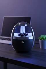 Magnetic Fluid Bluetooth Speaker lifestyle on dark minimal desk with blue ambient lighting